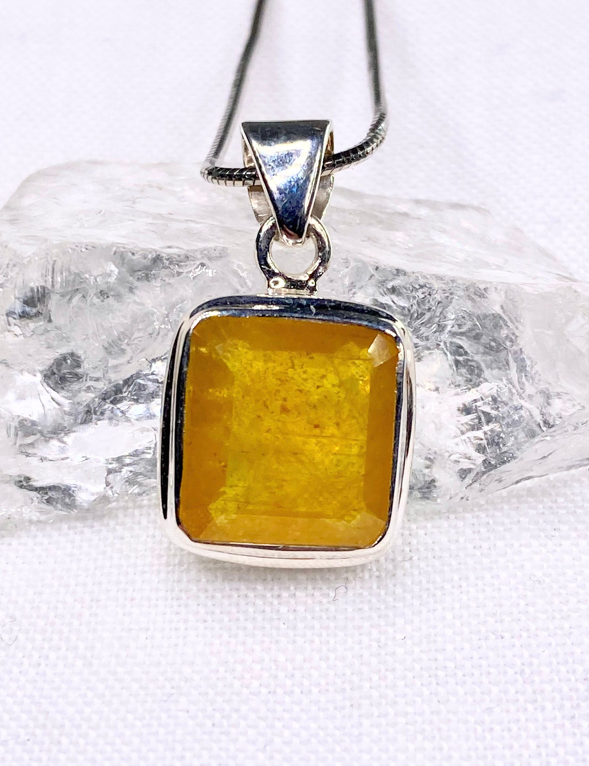 A Natural Yellow Sapphire and Silver Pendant.