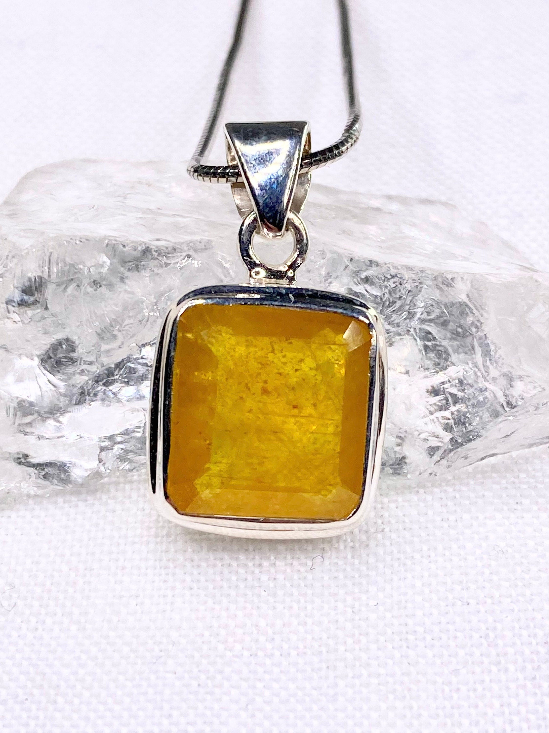 A Natural Yellow Sapphire and Silver Pendant.