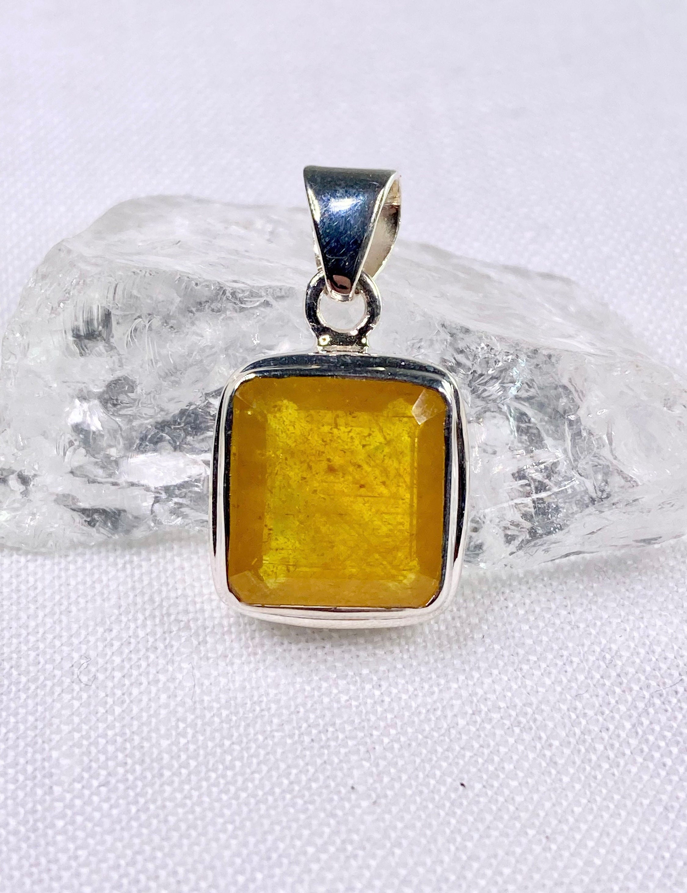 A Natural Yellow Sapphire and Silver Pendant.