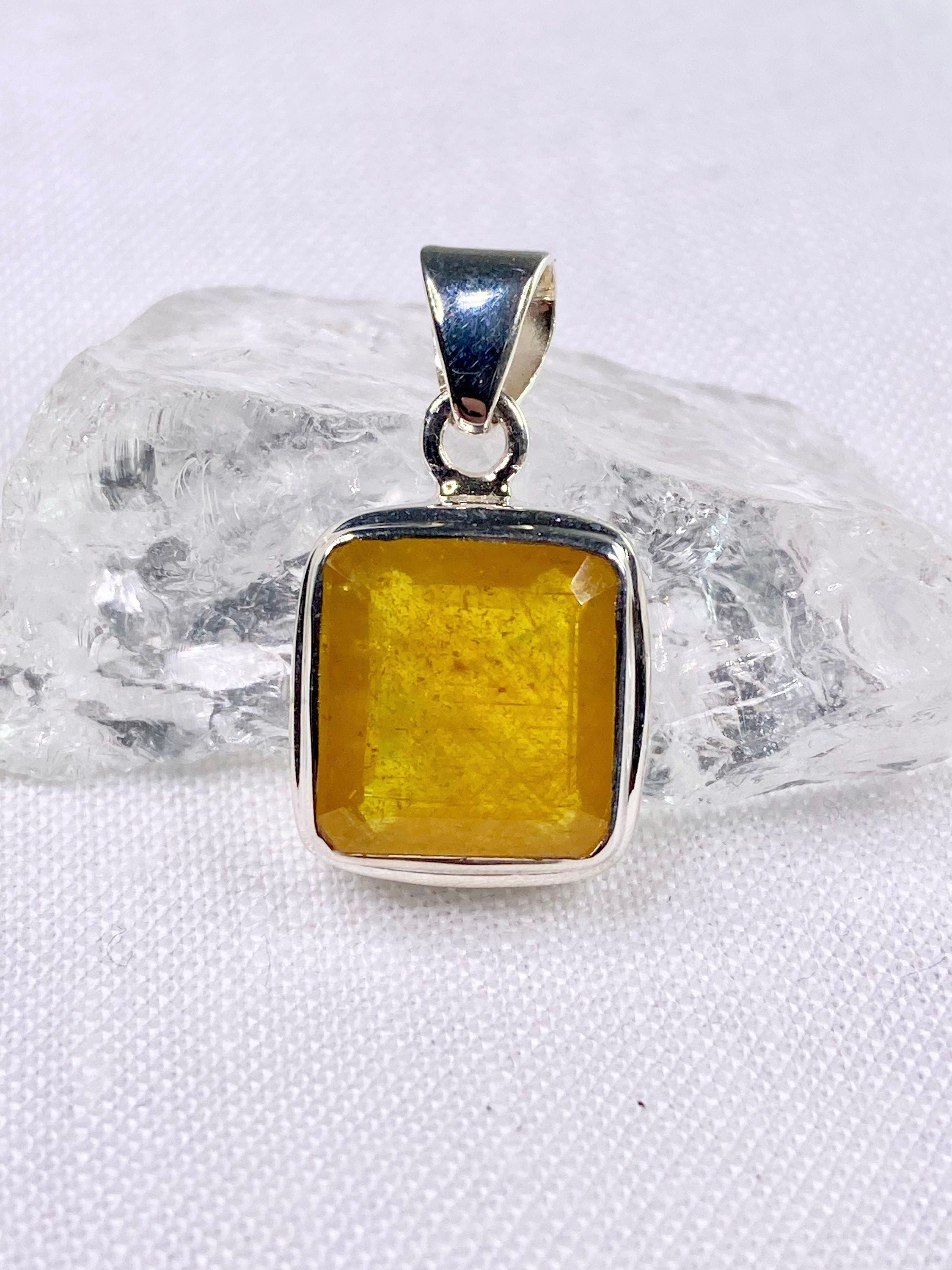 A Natural Yellow Sapphire and Silver Pendant.