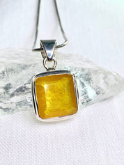 A Natural Yellow Sapphire and Silver Pendant.