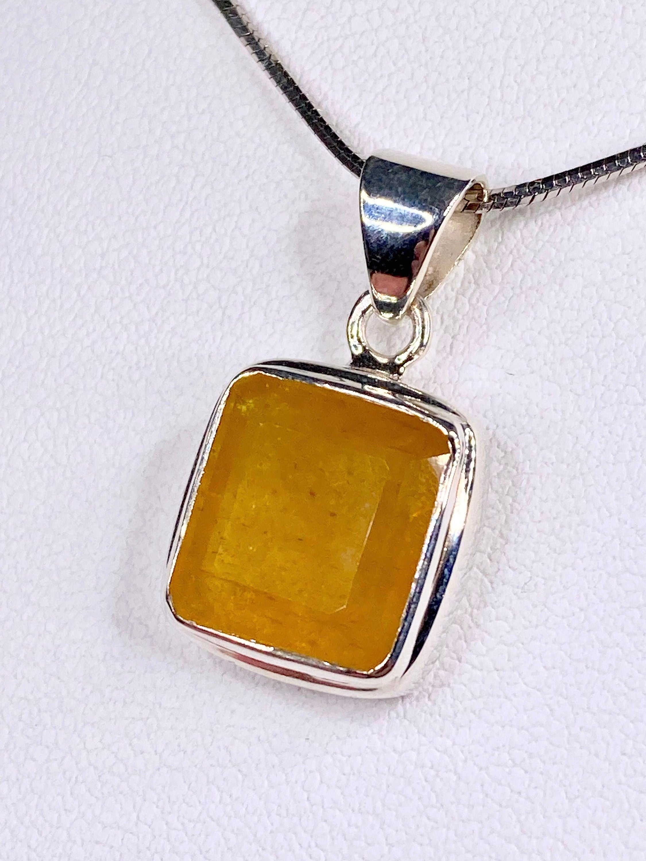 A Natural Yellow Sapphire and Silver Pendant.