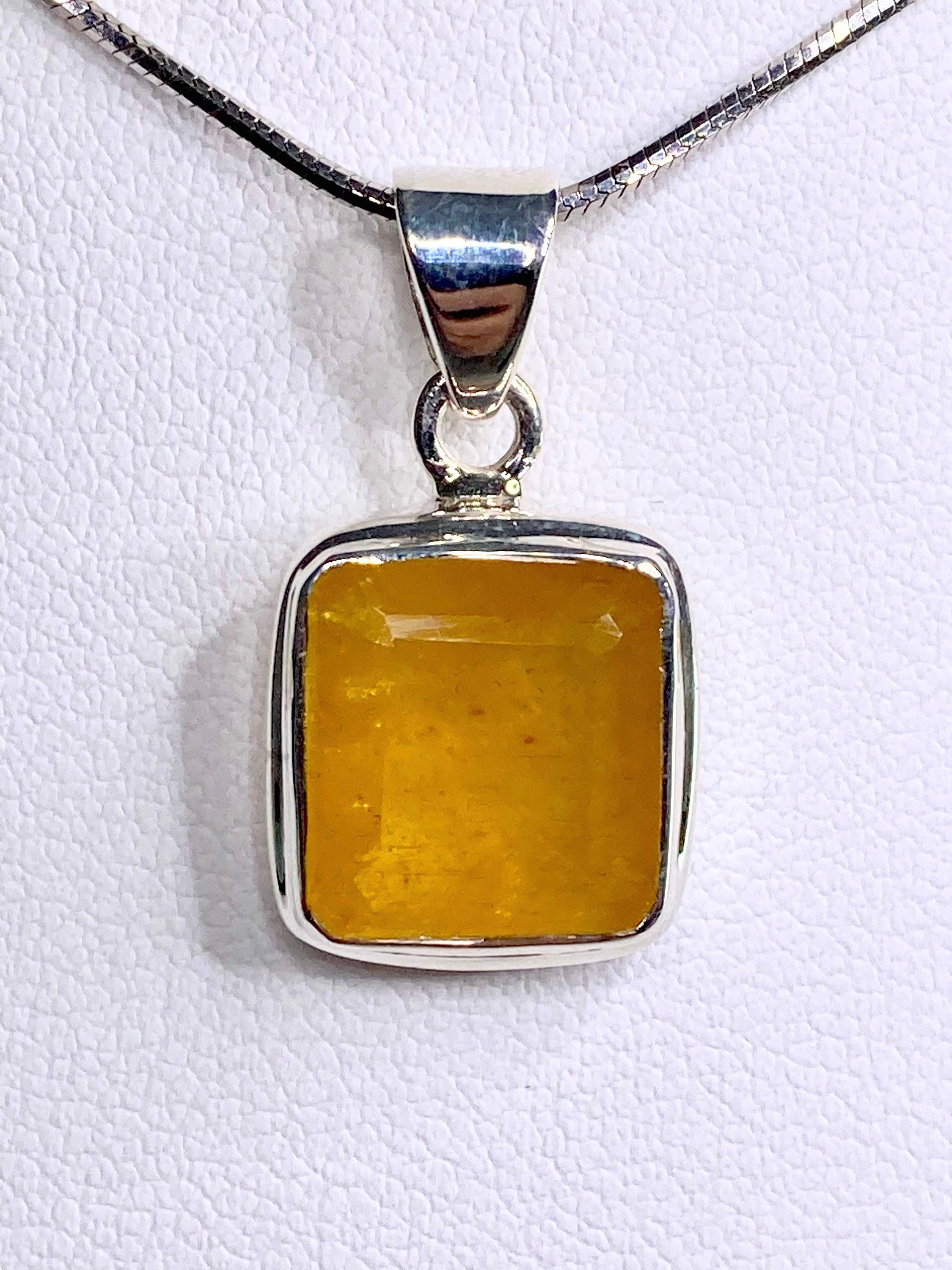 A Natural Yellow Sapphire and Silver Pendant.