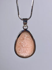 A High Grade Peach Scolecite and Silver Pendant.