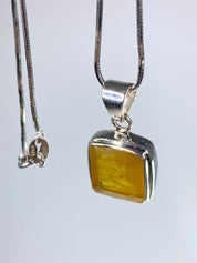 A Natural Yellow Sapphire and Silver Pendant.