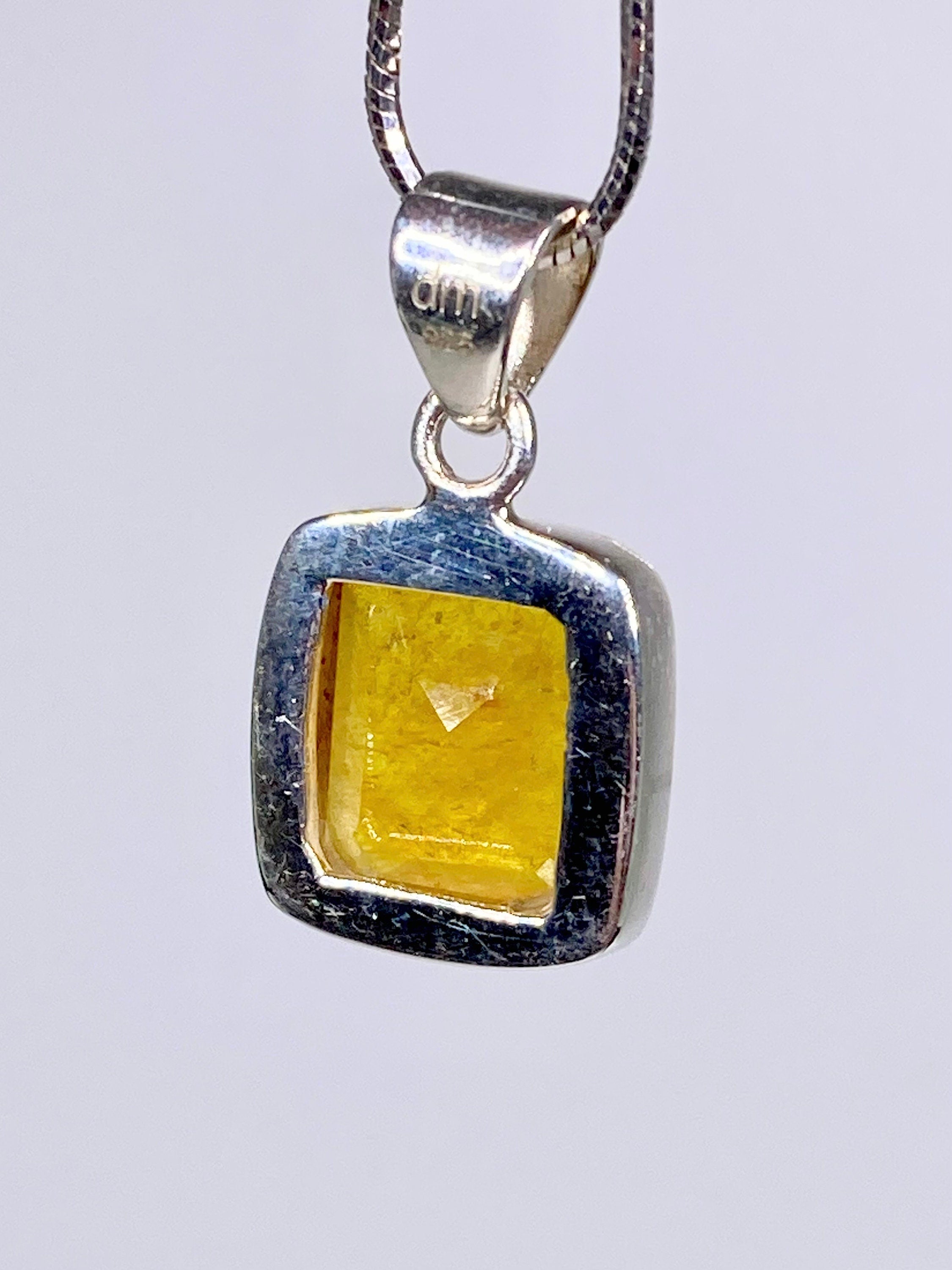 A Natural Yellow Sapphire and Silver Pendant.