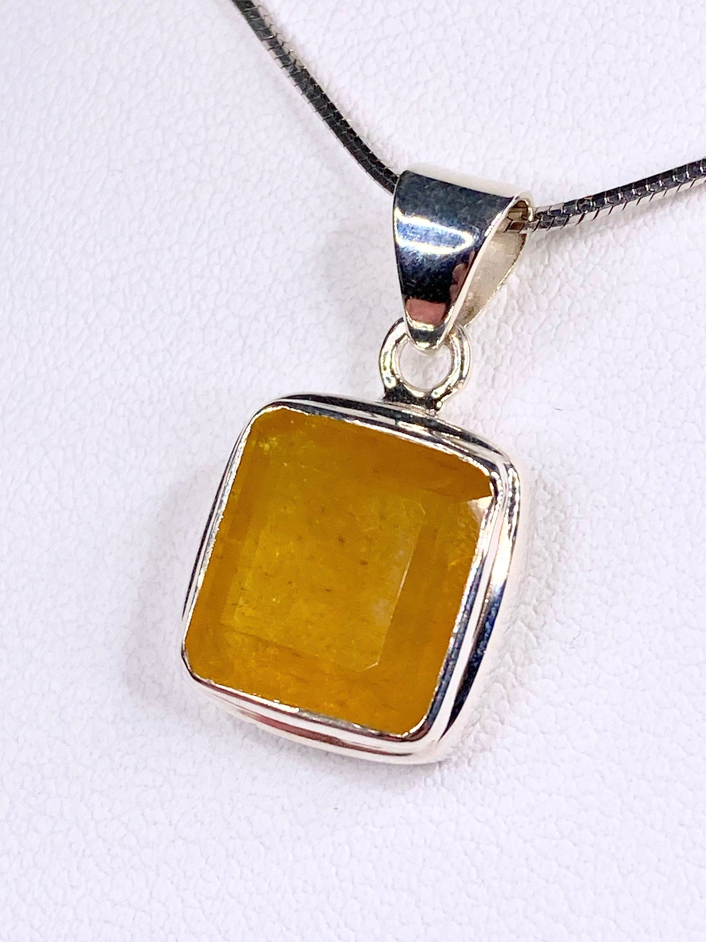 A Natural Yellow Sapphire and Silver Pendant.